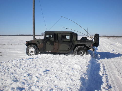 guard units knocking down snow buildup along a rural driveway