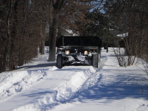 Guard vehicle driving down snowy roadway