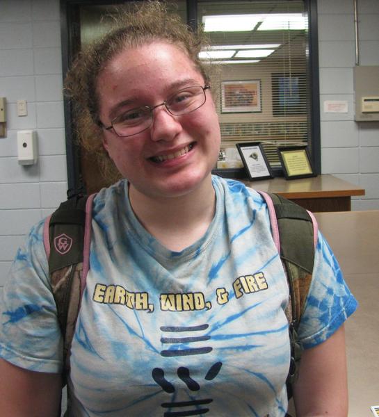 Student recipient wearing Earth, Wind, and Fire t-shirt