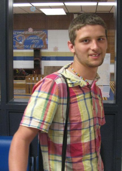 Male student recipient wearing plaid button-up shirt