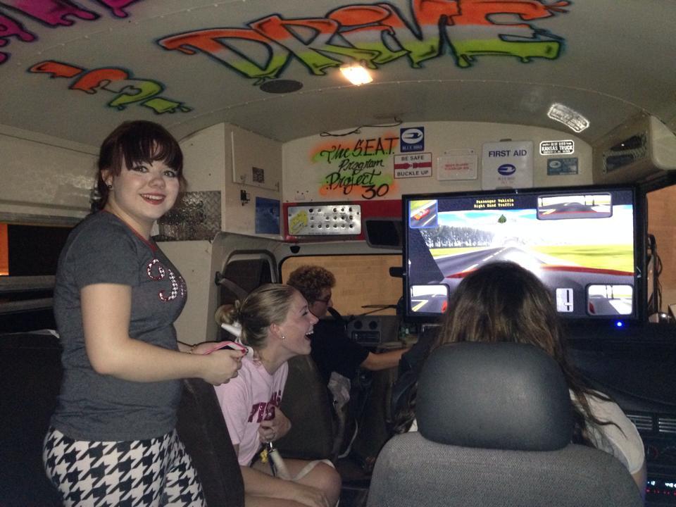 Students inside The S.E.A.T. bus doing driving simulation