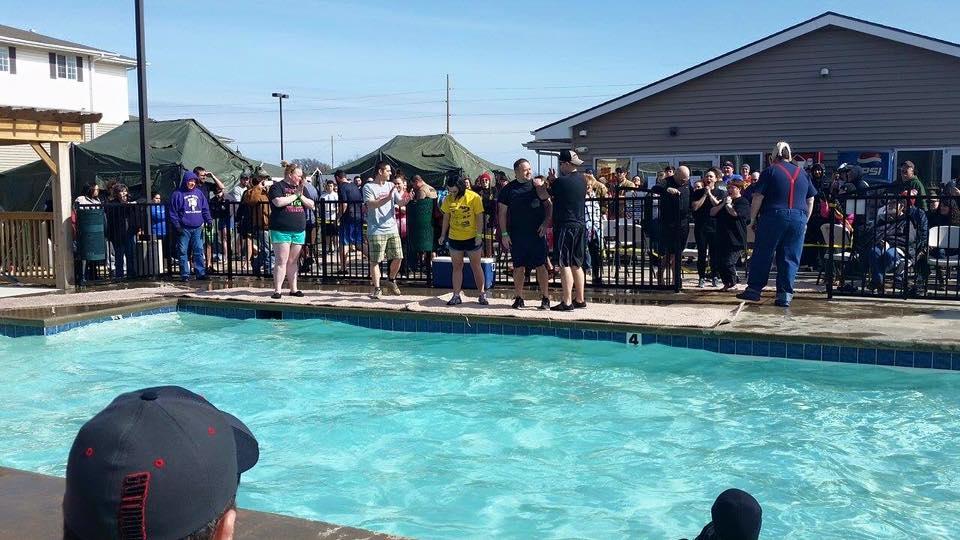Officers standing around a pool ready to jump in