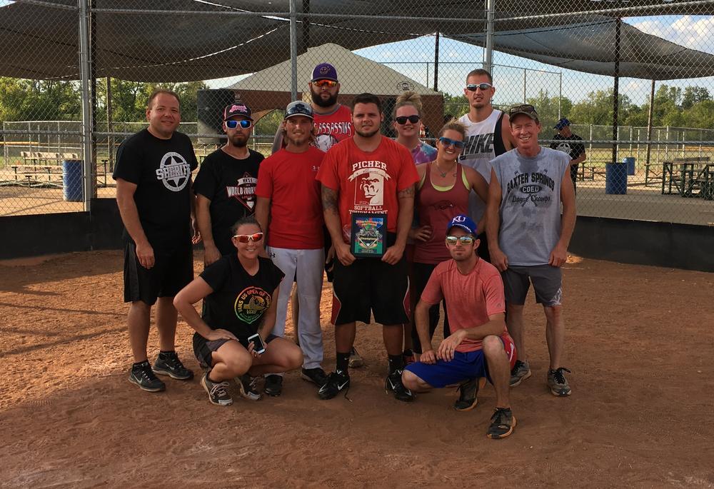 Sheriff David Groves presents OFF the championship plaque following the Badge Bash for Christmas Cash Softball Tournament