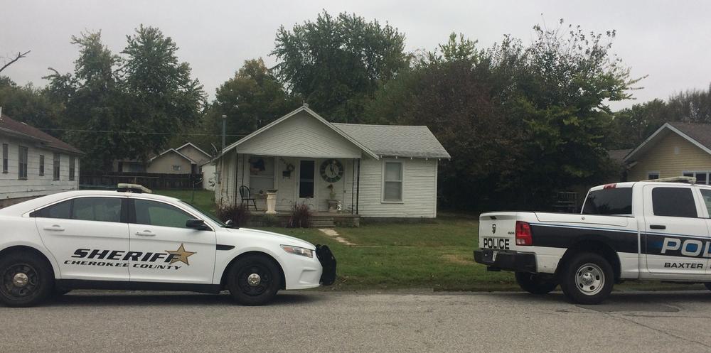 two police vehicles in front of residence