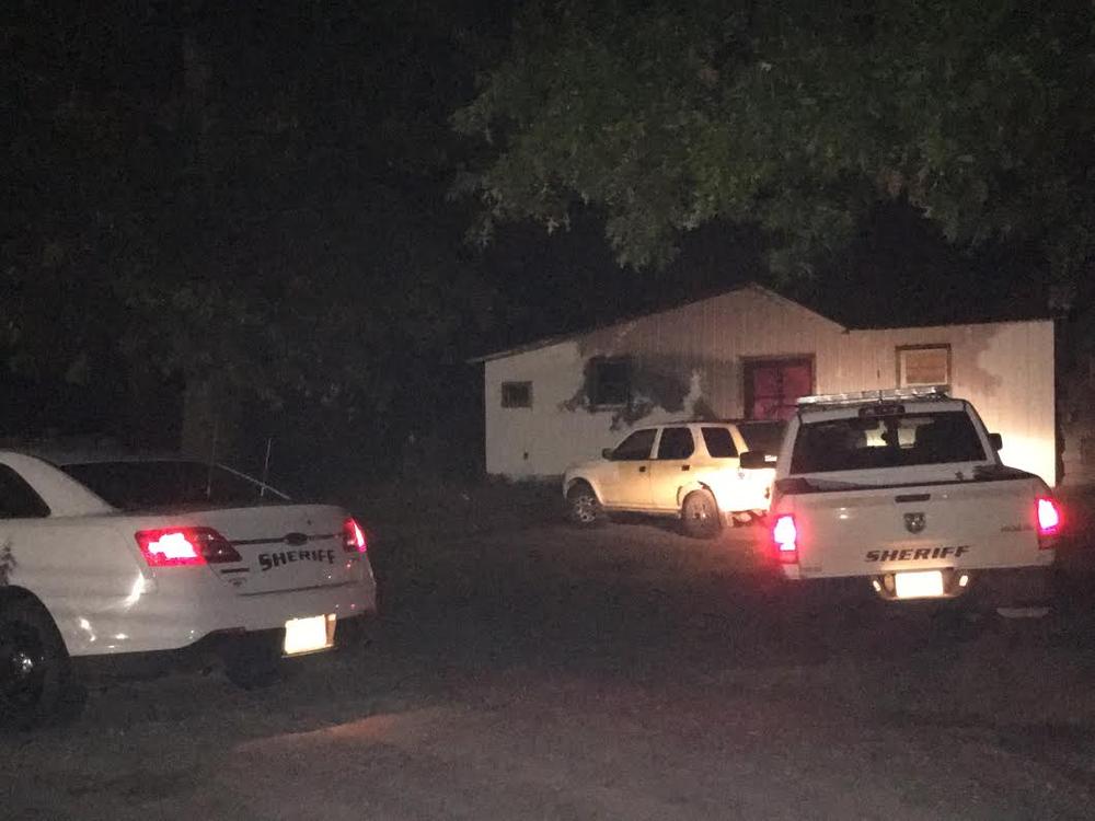 two police vehicles parked outside residence at night