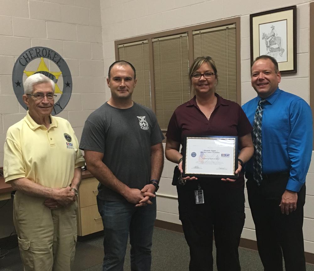 Larry Graham, CO Powell, Captain Tippie and Sheriff Groves standing with Patriot Award