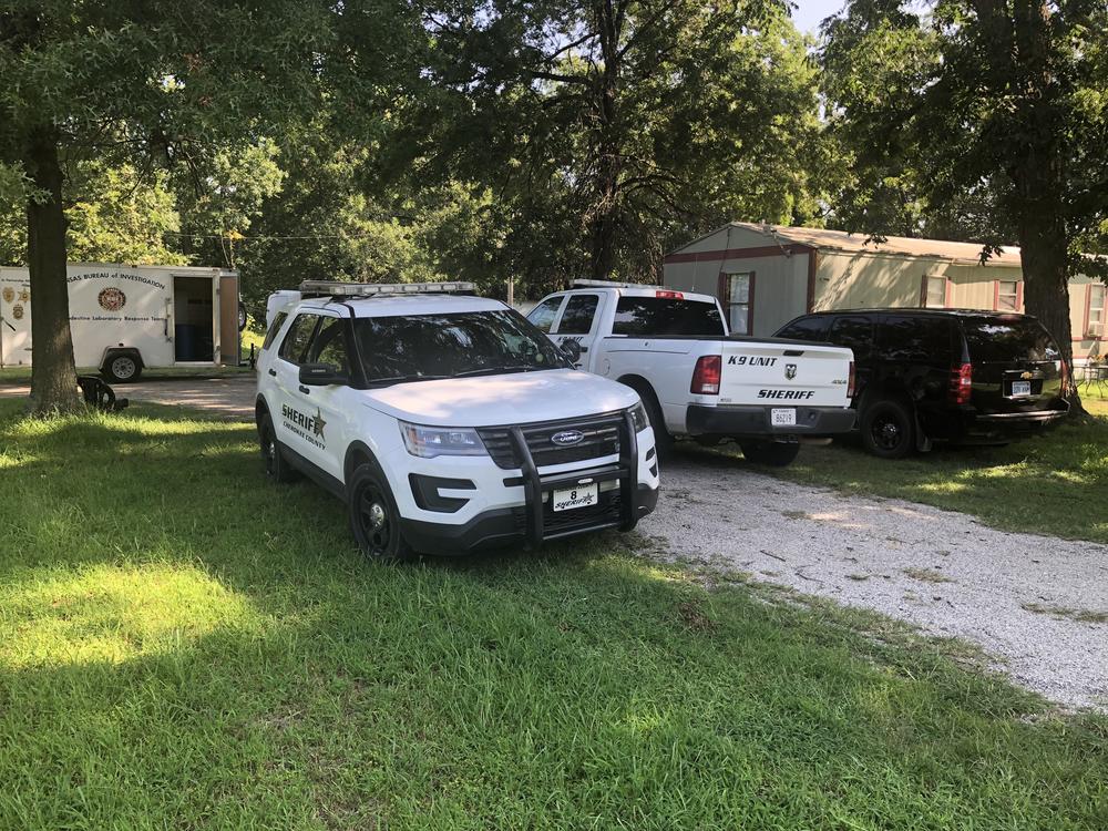 Scene of the search warrant with 2 police vehicles