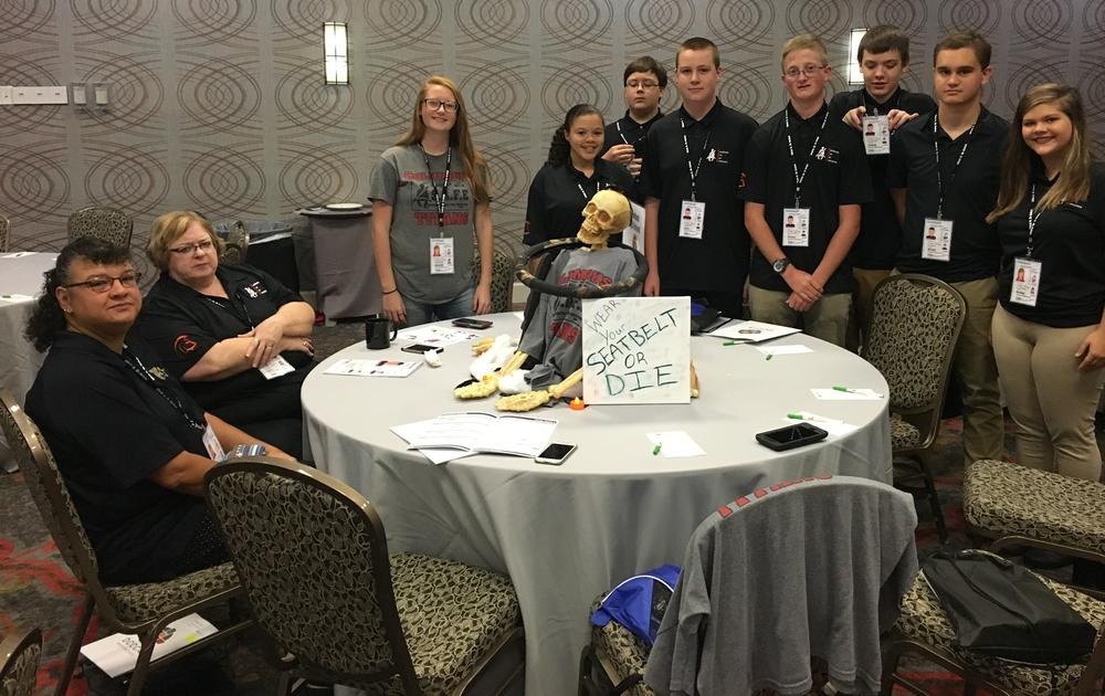 Columbus SAFE Team, a few members sitting and most standing at a round table