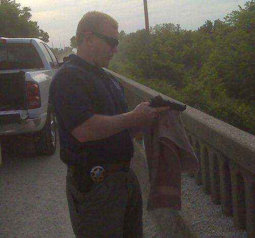 Detective Tippie dries one of the recovered guns