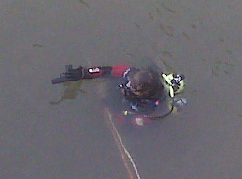 Diver surfaces with recovered item